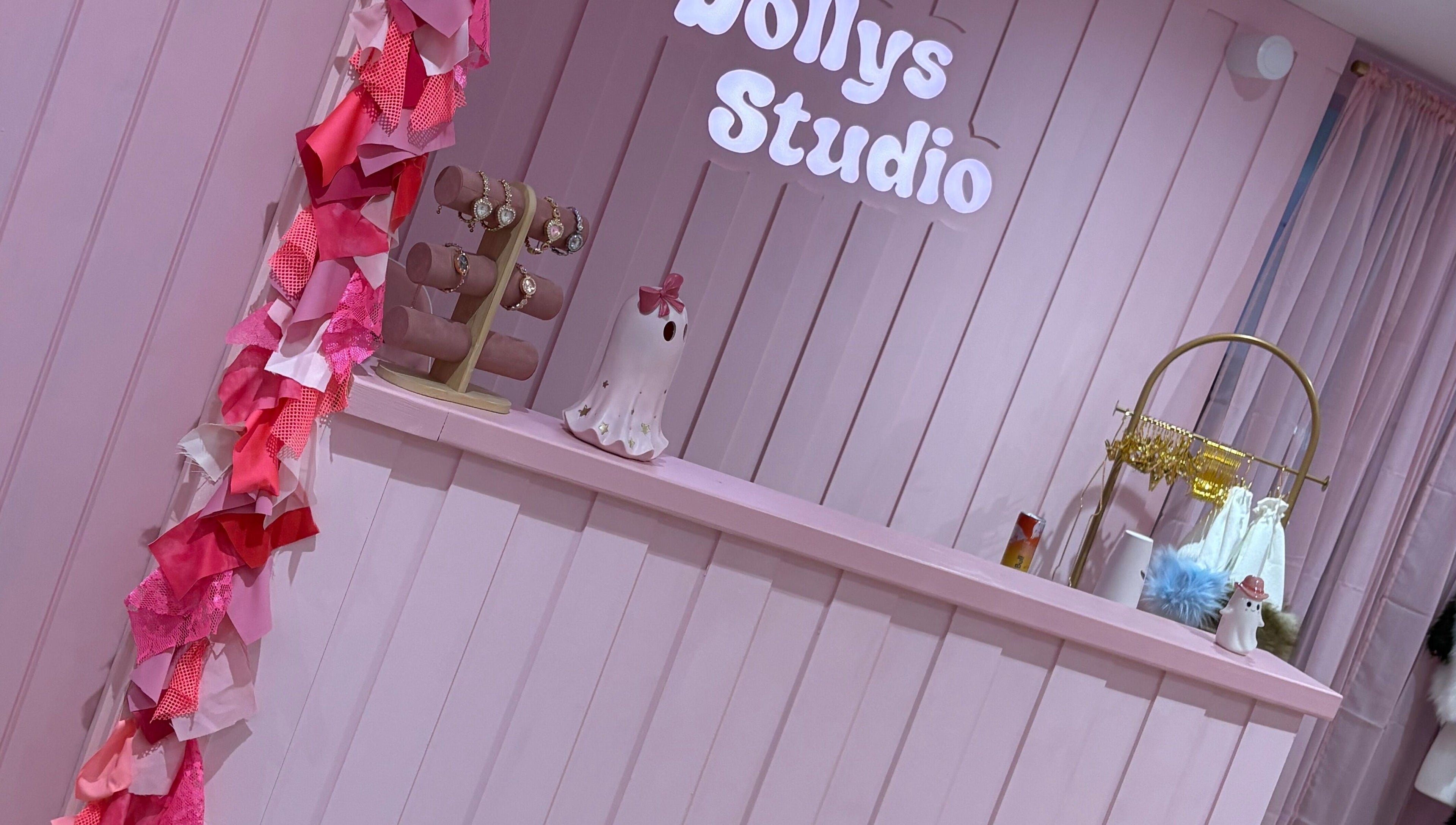 Welcoming pink decor at Dollys Studio, Bradford, England, GB, showcasing elegant jewelry display.