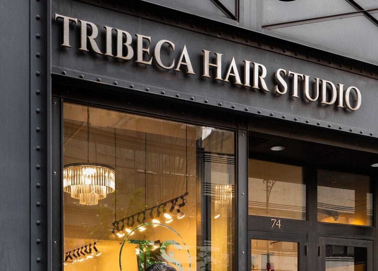 Front view of Tribeca Hair Studio NYC entrance in New York, New York, US with a stylish glass facade.