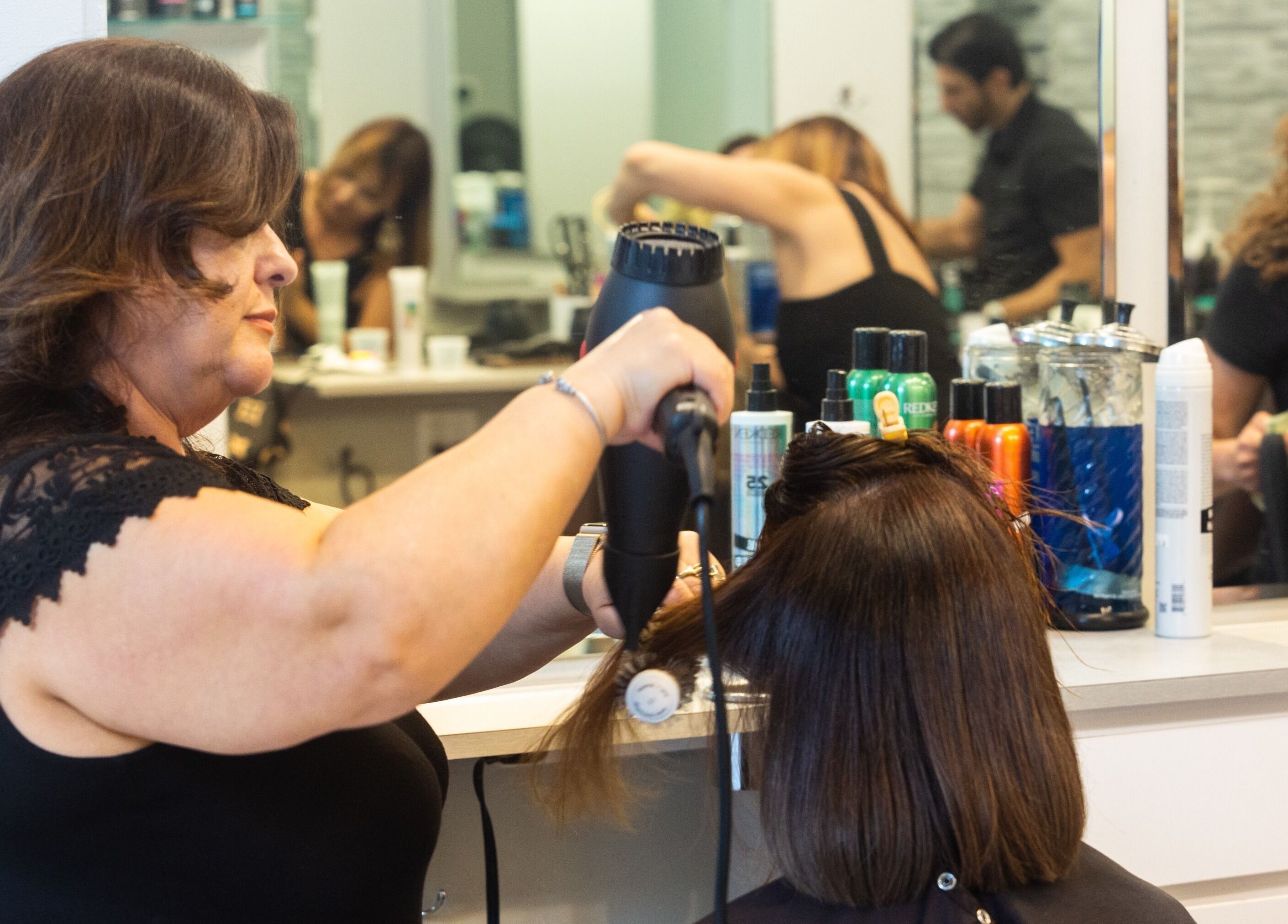 Hair styling at Tribeca Hair Studio NYC in New York, New York, US with expert stylist using a blow dryer.