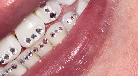 Close-up of sparkling teeth embellishments at Lashed By Audrey, Lisarow, New South Wales, AU.
