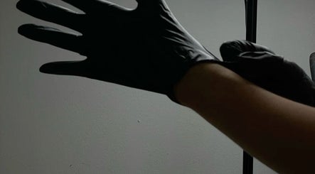 Professional in gloves at KuratedbyKirsty, Roodepoort, Gauteng, ZA, ensuring high hygiene standards.