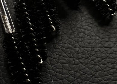 Close-up of mascara brushes on a textured surface at KuratedbyKirsty, Roodepoort, Gauteng, ZA.