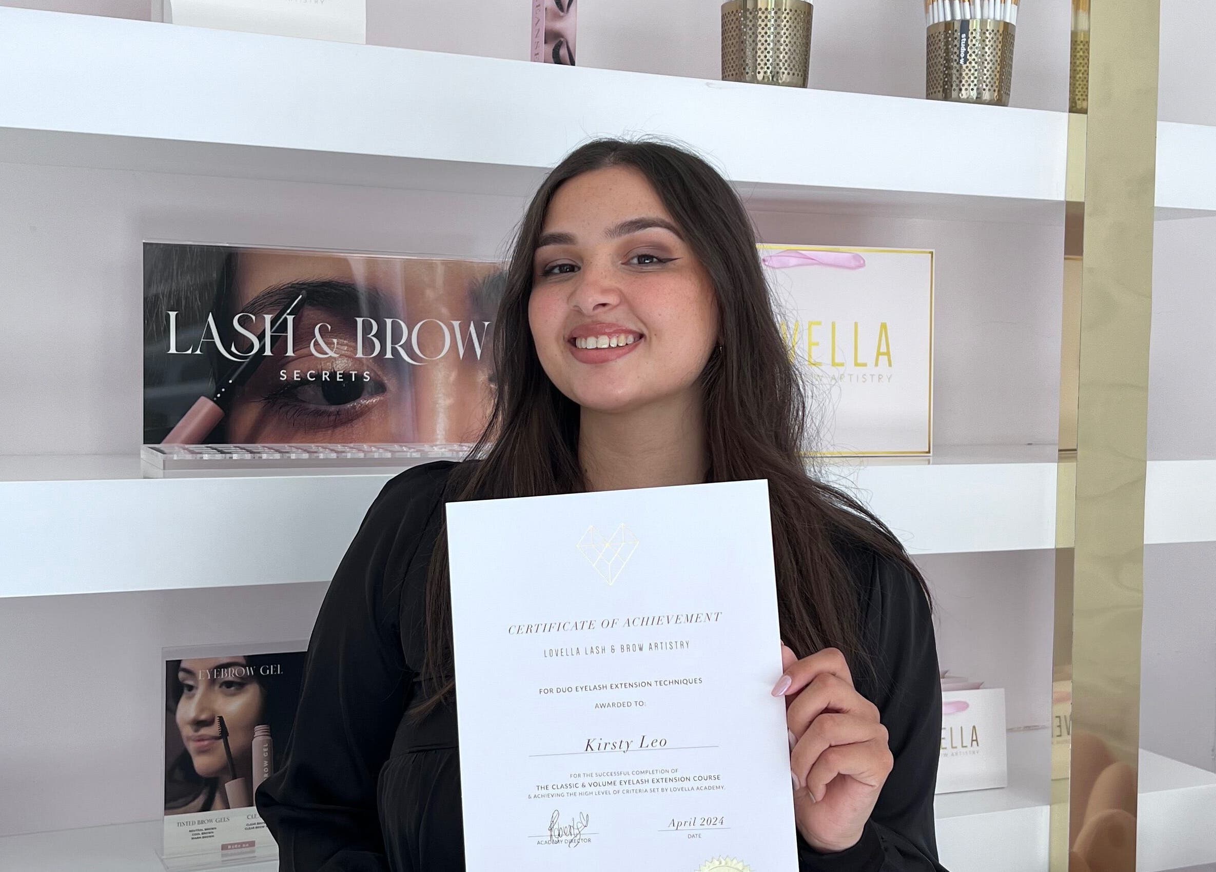 Woman at Kurated by Kirsty, Gqeberha, Eastern Cape, ZA with lash and brow products and certificate.