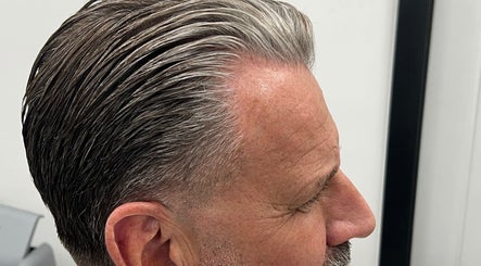 Side profile haircut at Himan mobile barber, Lichfield, England, GB, showcasing sleek grey hair styling.