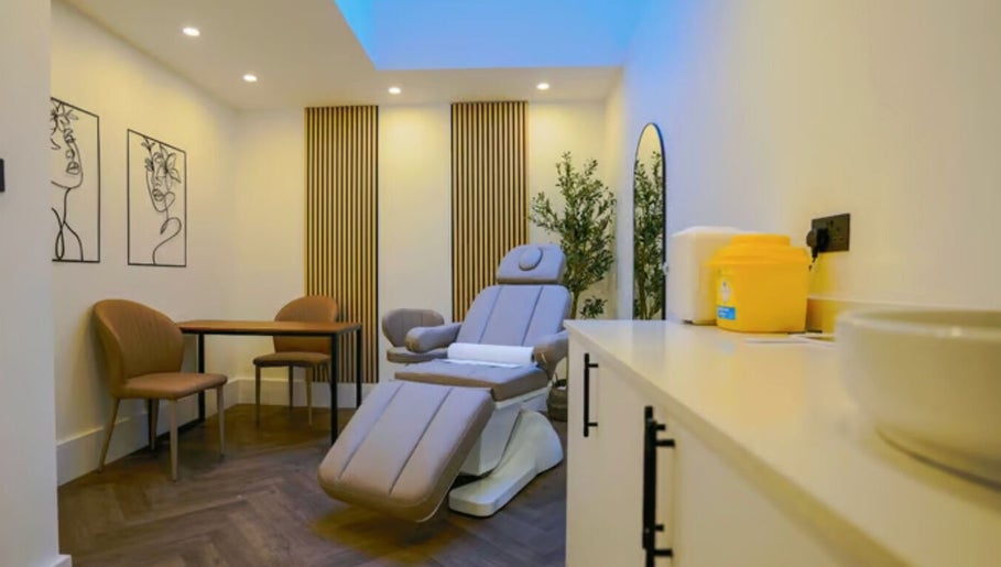 Modern treatment room at Studio Anji Aesthetics, London, England, GB, featuring a plush chair and serene decor.