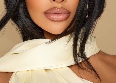 Elegant woman with glossy lips and silk scarf at Studio Anji Aesthetics, London, England, GB.