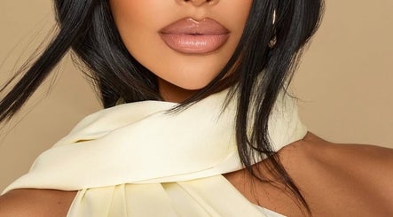 Elegant woman with glossy lips and silk scarf at Studio Anji Aesthetics, London, England, GB.