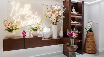 Floral decor and 'Hello Beautiful' sign at Royal Siam Spa, Abu Dhabi, AE. Elegant spa ambiance.