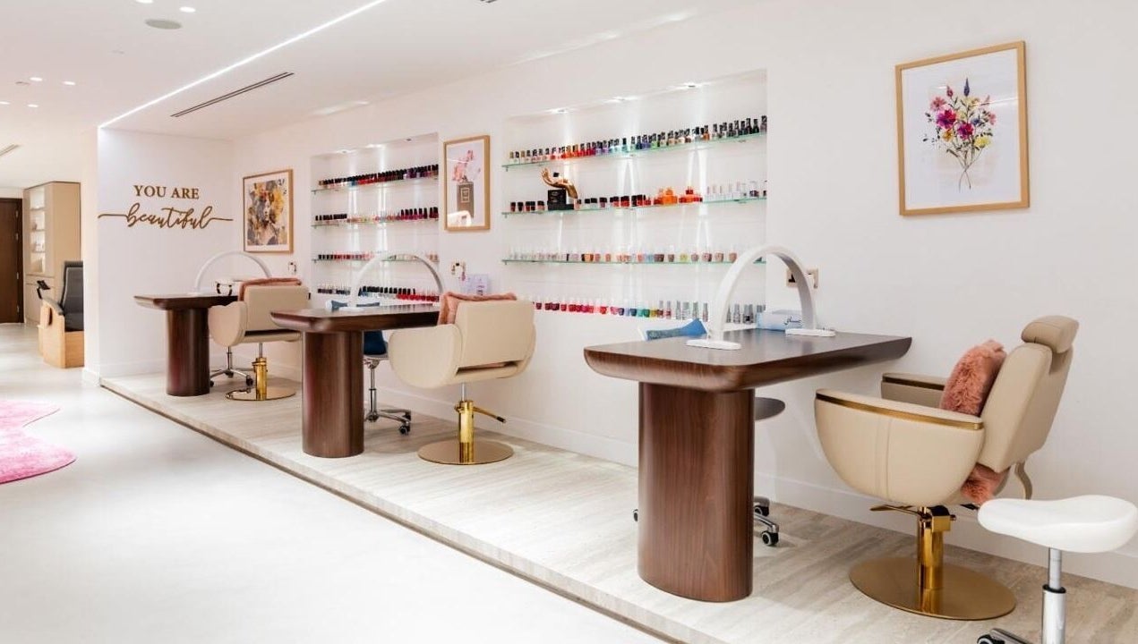 Royal Siam Spa's elegant nail station in Abu Dhabi, AE featuring modern decor and vibrant polish displays.