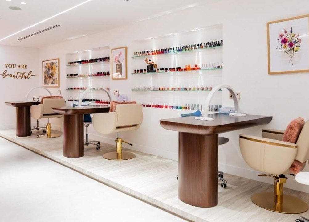 Royal Siam Spa's elegant nail station in Abu Dhabi, AE featuring modern decor and vibrant polish displays.