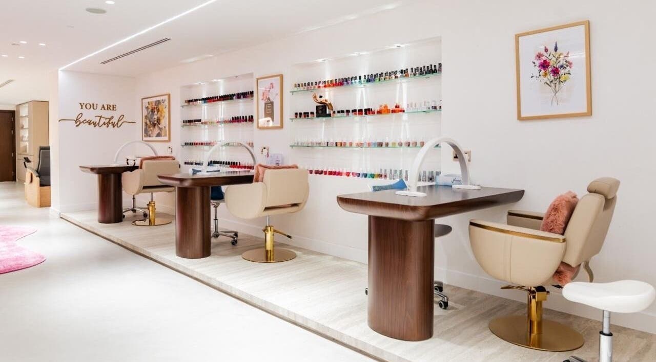 Royal Siam Spa's elegant nail station in Abu Dhabi, AE featuring modern decor and vibrant polish displays.