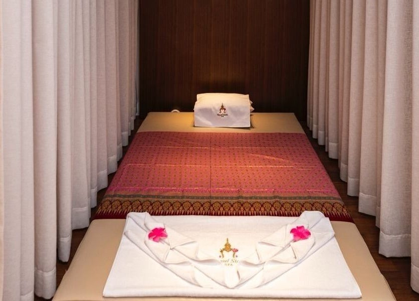 Elegant massage bed setup at Royal Siam Spa in Abu Dhabi, AE, featuring plush linens and serene ambiance.