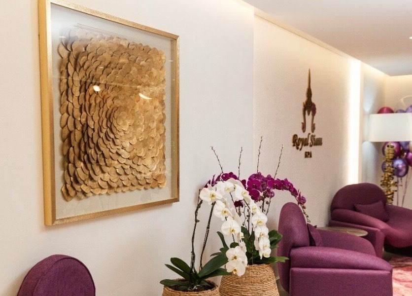 Luxurious lounge at Royal Siam Spa, Abu Dhabi, AE with orchids and modern decor.