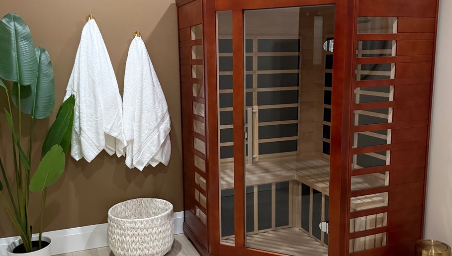 Elegant sauna room at Golden Sweat in London, Ontario, CA with wooden structure and plush towels.