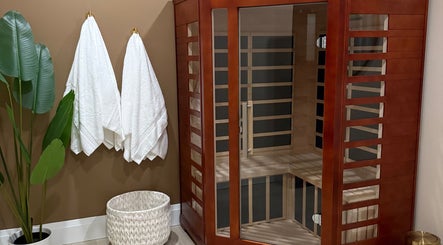 Elegant sauna room at Golden Sweat in London, Ontario, CA with wooden structure and plush towels.