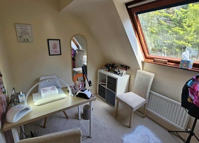 Cozy nail studio at Satori Nails, Peterborough, England, GB with modern decor and lush greenery view.