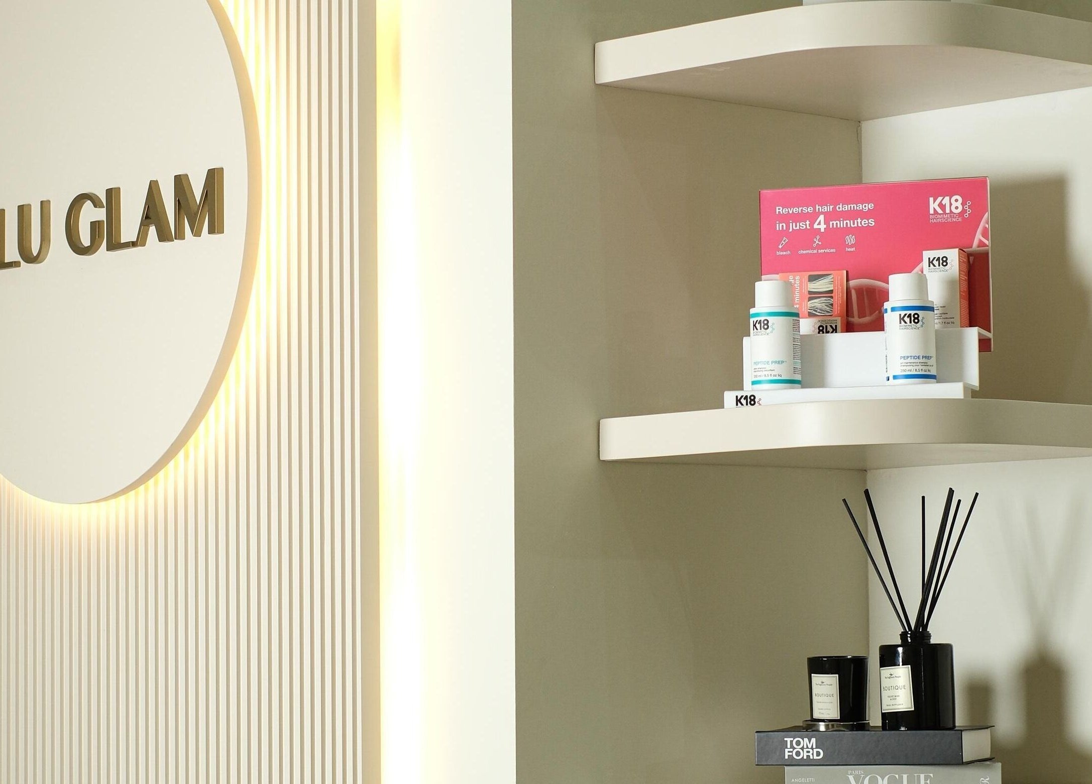 Product display shelves at LuluGlam Lounge in Dubai, Dubai, AE, showcasing beauty items.