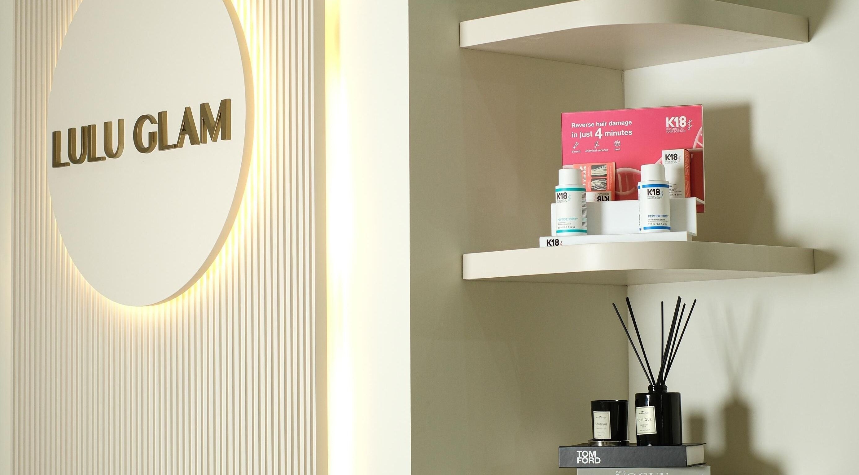 Product display shelves at LuluGlam Lounge in Dubai, Dubai, AE, showcasing beauty items.