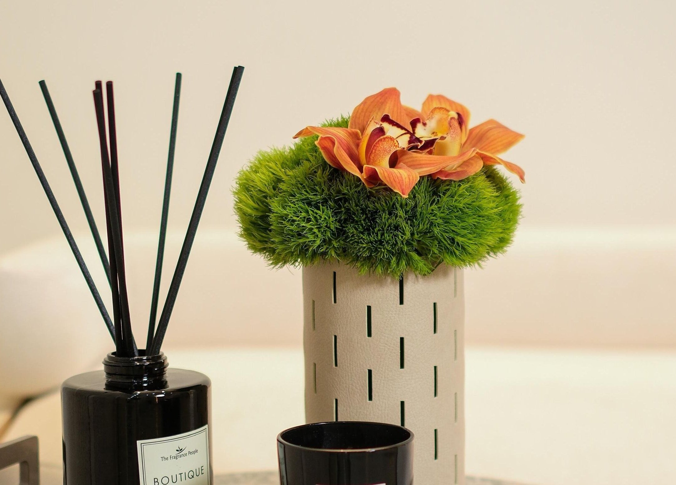 Chic vase with vibrant flowers and diffuser at LuluGlam Lounge, Dubai, Dubai, AE, embodying relaxation.