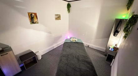Tranquil massage room at The Stress Compress in Manchester, England, GB with soothing decor and dim lighting.