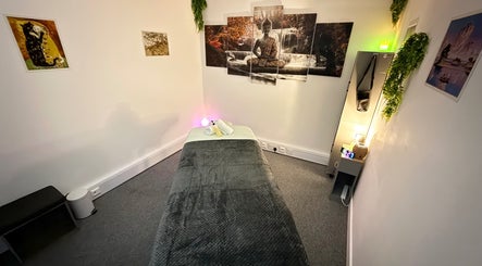 Relaxing massage room at The Stress Compress, Manchester, England, GB with calming decor and soft lighting.