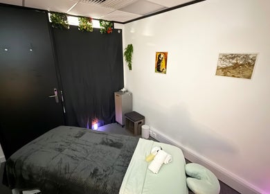 Peaceful massage room at The Stress Compress, Manchester, England, GB with a cozy bed and calming decor.