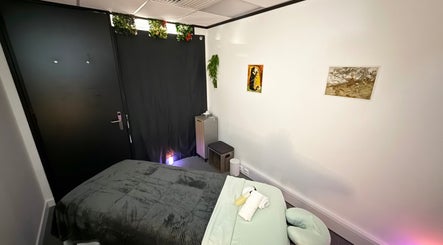 Peaceful massage room at The Stress Compress, Manchester, England, GB with a cozy bed and calming decor.