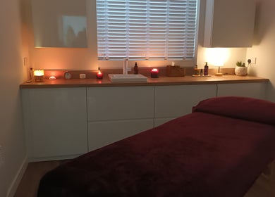 Serene massage room at Velvet Lily Massage, Dunfermline, Scotland, GB with ambient lighting and a massage table.