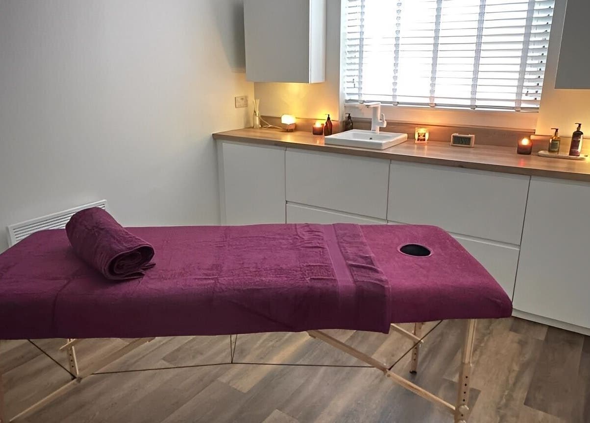 Serene massage room at Velvet Lily Massage, Dunfermline, Scotland, GB, featuring a cozy ambiance with candles.