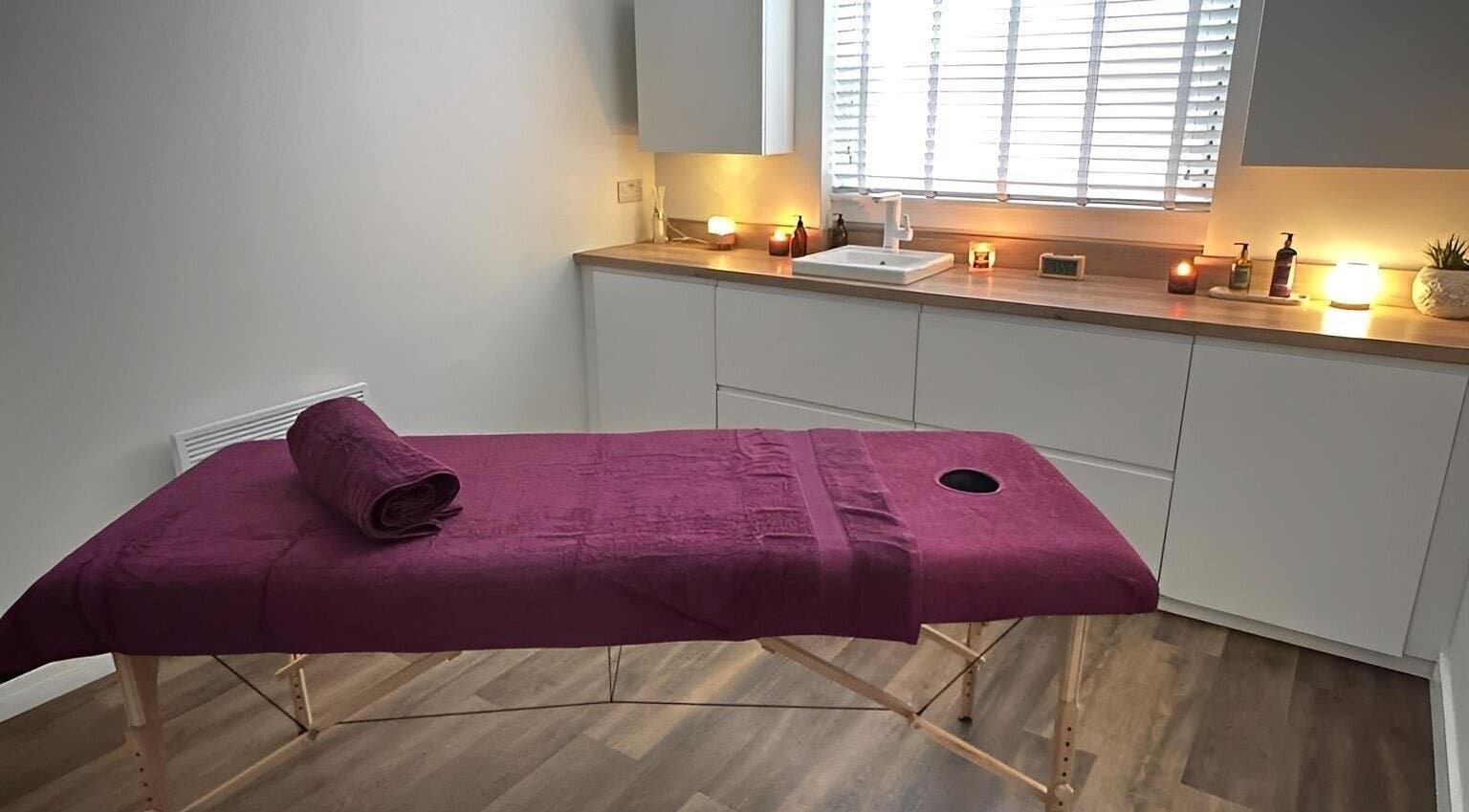 Serene massage room at Velvet Lily Massage, Dunfermline, Scotland, GB, featuring a cozy ambiance with candles.