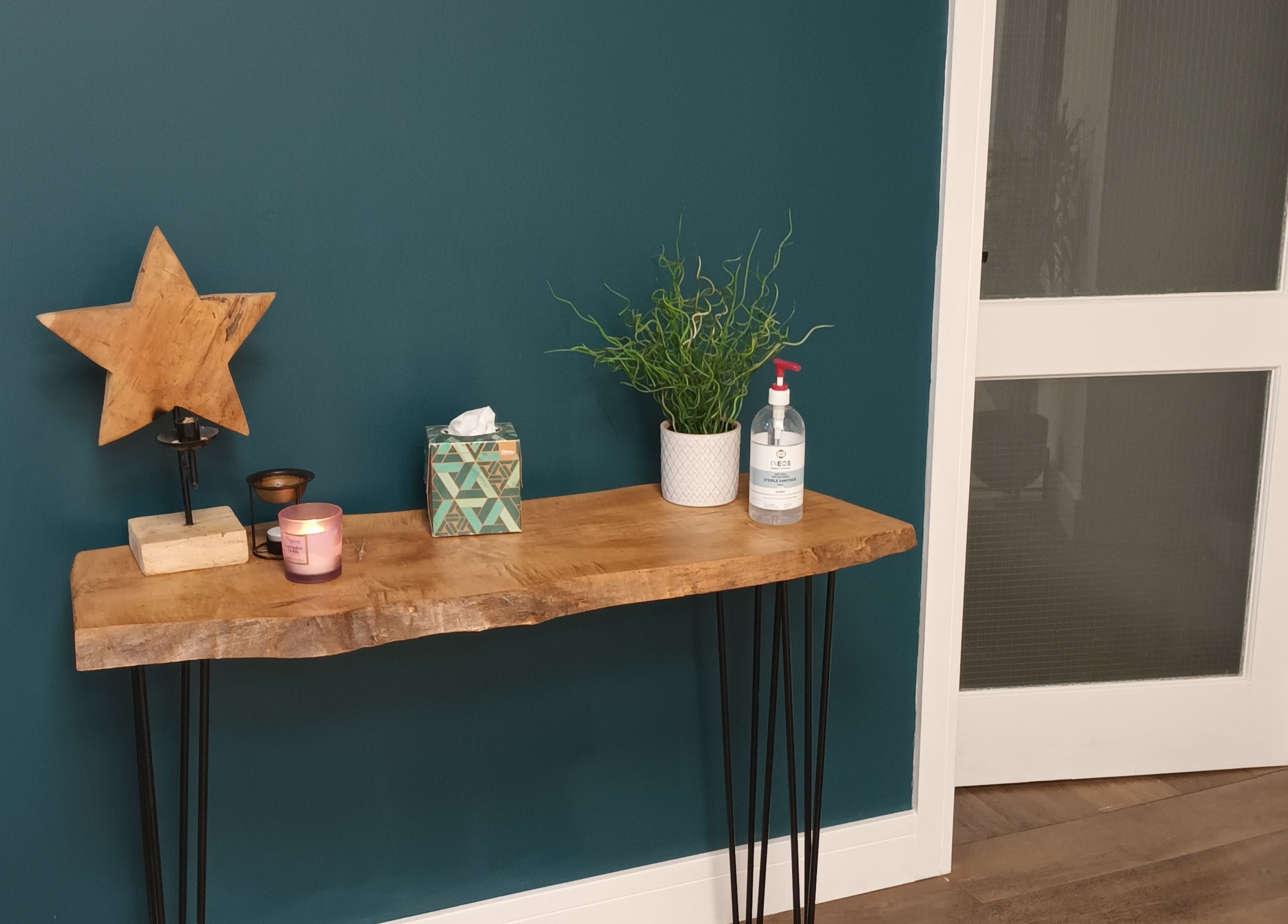 Welcoming decor at Velvet Lily Massage, Dunfermline, Scotland with a star ornament and potted plant.