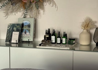 Shelf with wellness books and oils at Nicola Meir Holistic Therapies, Sidcup, GB.
