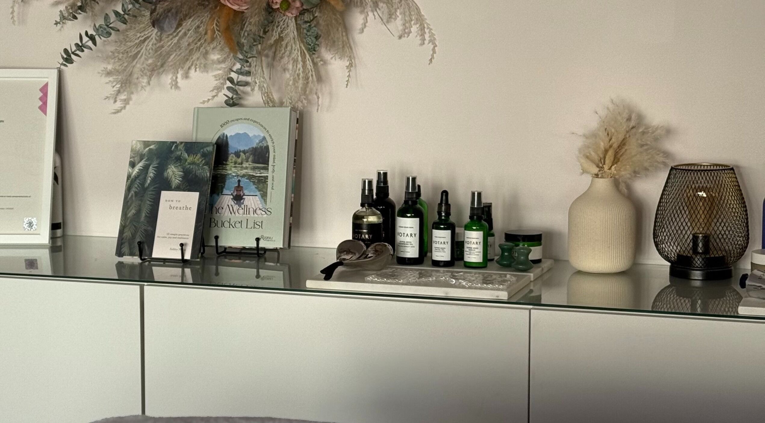 Shelf with wellness books and oils at Nicola Meir Holistic Therapies, Sidcup, GB.