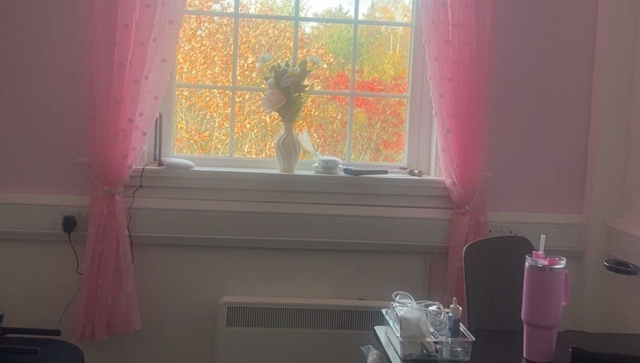 Charming pink room with a vase and tools at Luna Glow, Edinburgh, Scotland, GB, providing a serene beauty ambiance.