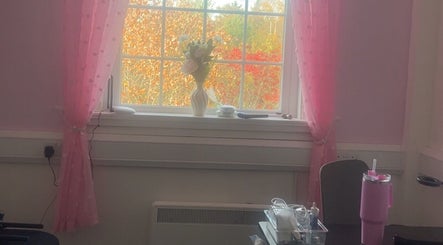 Charming pink room with a vase and tools at Luna Glow, Edinburgh, Scotland, GB, providing a serene beauty ambiance.