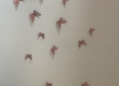 Wall adorned with butterfly decor at Luna Glow, Edinburgh, Scotland, GB, enhancing the calming ambiance.