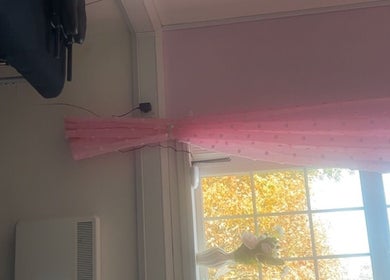 Cozy room with pink curtains at Luna Glow, Edinburgh, Scotland, GB, creating a tranquil wellness space.