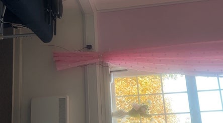 Cozy room with pink curtains at Luna Glow, Edinburgh, Scotland, GB, creating a tranquil wellness space.
