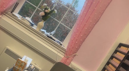 Elegant window view at Luna Glow, Edinburgh, Scotland, GB, featuring pink curtains and decorative vase.