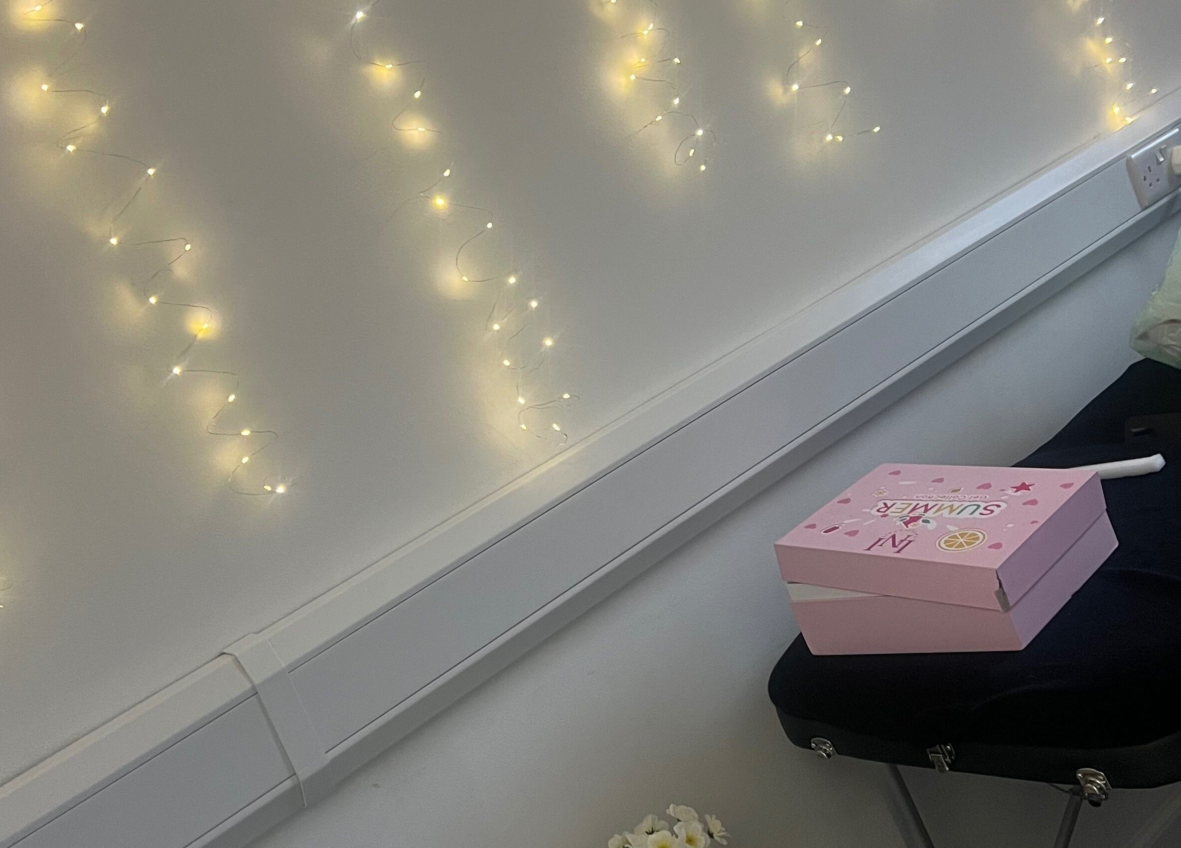 Luna Glow in Edinburgh, Scotland, GB featuring soft fairy lights and a pink box on a massage table.