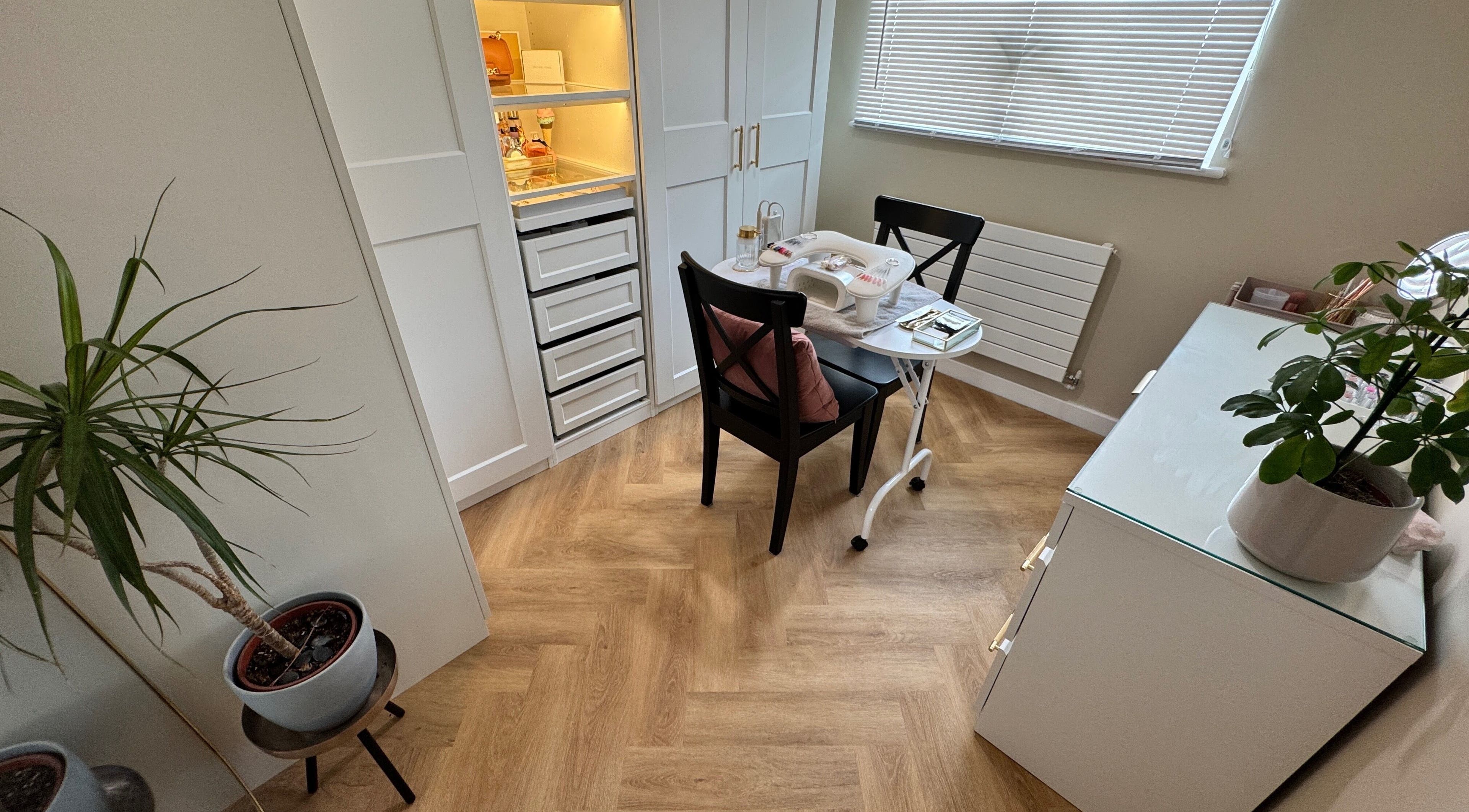 Cozy manicure station at Nova Noir Nails, Peacehaven, England, GB with stylish decor and lush plants.