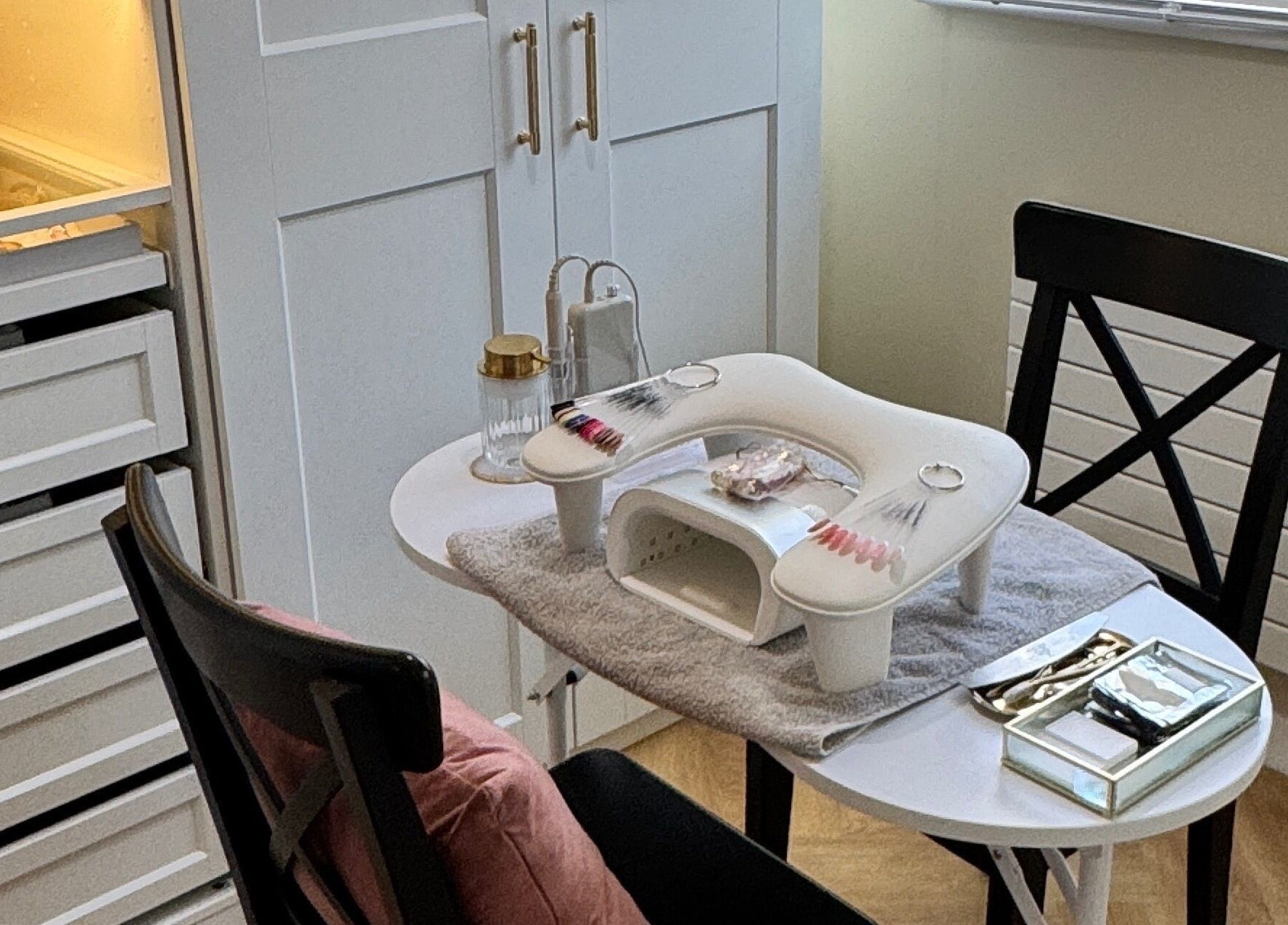 Nail station at Nova Noir Nails in Peacehaven, England, GB, featuring manicure tools and a cozy setup.