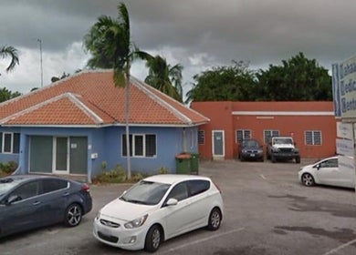 Exterior view of Glow by Amarii, a wellness center in Willemstad, CW, showcasing tropical architecture.