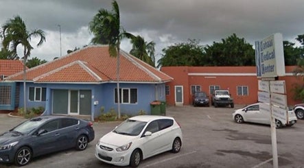 Exterior view of Glow by Amarii, a wellness center in Willemstad, CW, showcasing tropical architecture.