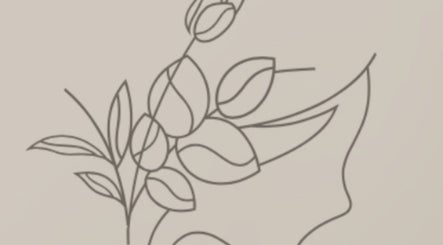 Minimalist line art of a face with leaves at Glow by Amarii, Willemstad, CW.