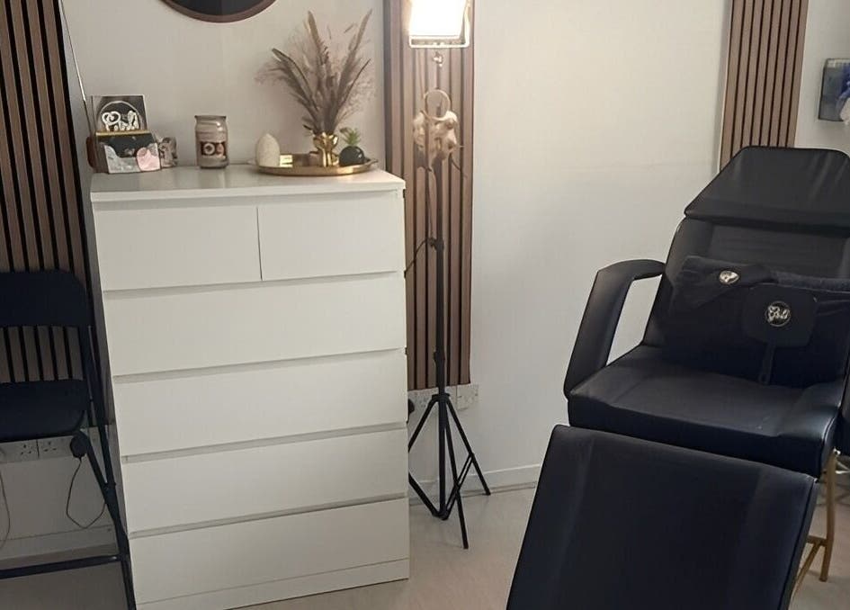 Beauty room at Hey Girl Beauty and Aesthetics, Birkenhead, England, GB, with comfortable black chair and chic decor.