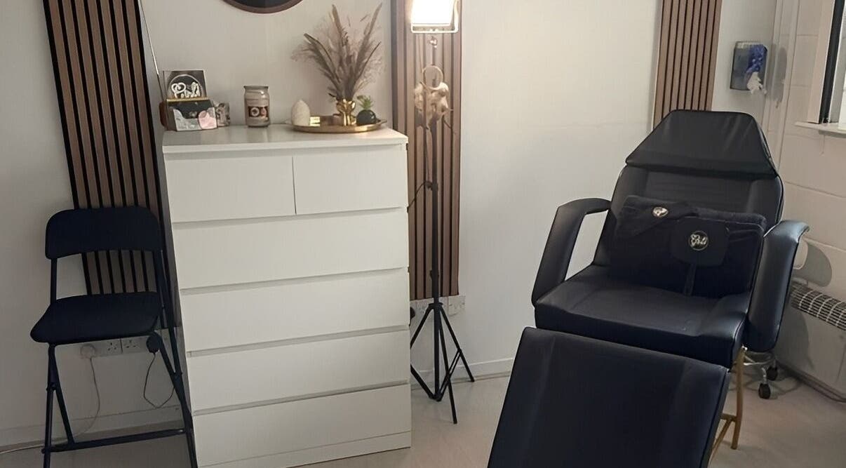 Beauty room at Hey Girl Beauty and Aesthetics, Birkenhead, England, GB, with comfortable black chair and chic decor.