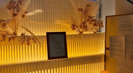 Warm lit reception at Ad Astra massage, Trimbach, Solothurn, CH, featuring elegant floral decor.