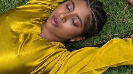 A woman in a golden dress relaxes on grass at For Angels, Dublin, County Dublin, IE.