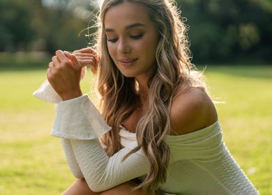 Woman enjoying sunlight in a serene garden at For Angels, Dublin, County Dublin, IE.